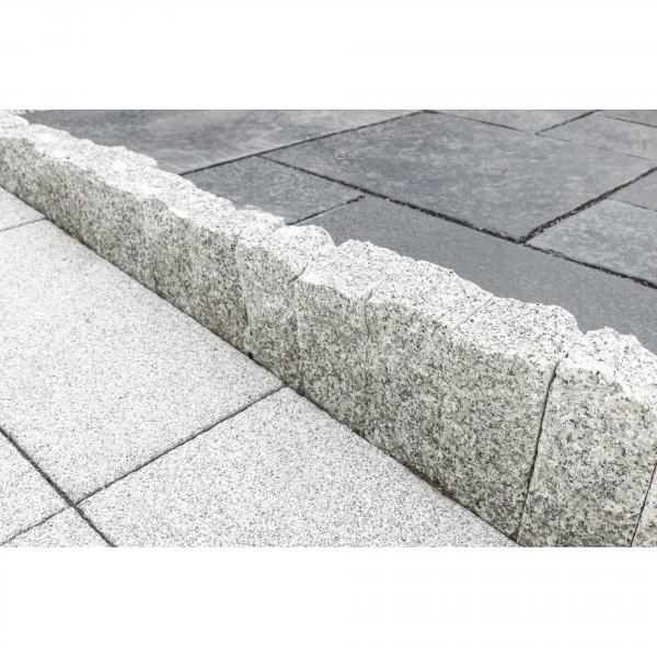 Svetlá žulová palisáda z línie Bianco Nero od STONE TRADE s jemne štiepanou textúrou, ideálna pre moderné olemovanie záhonov.