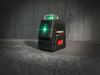 Detail zapnutého akumulátorového krížového líniového lasera Parkside PKLLP 360 B3 so svietiacim zeleným lúčom v interiéri od stonetrade.